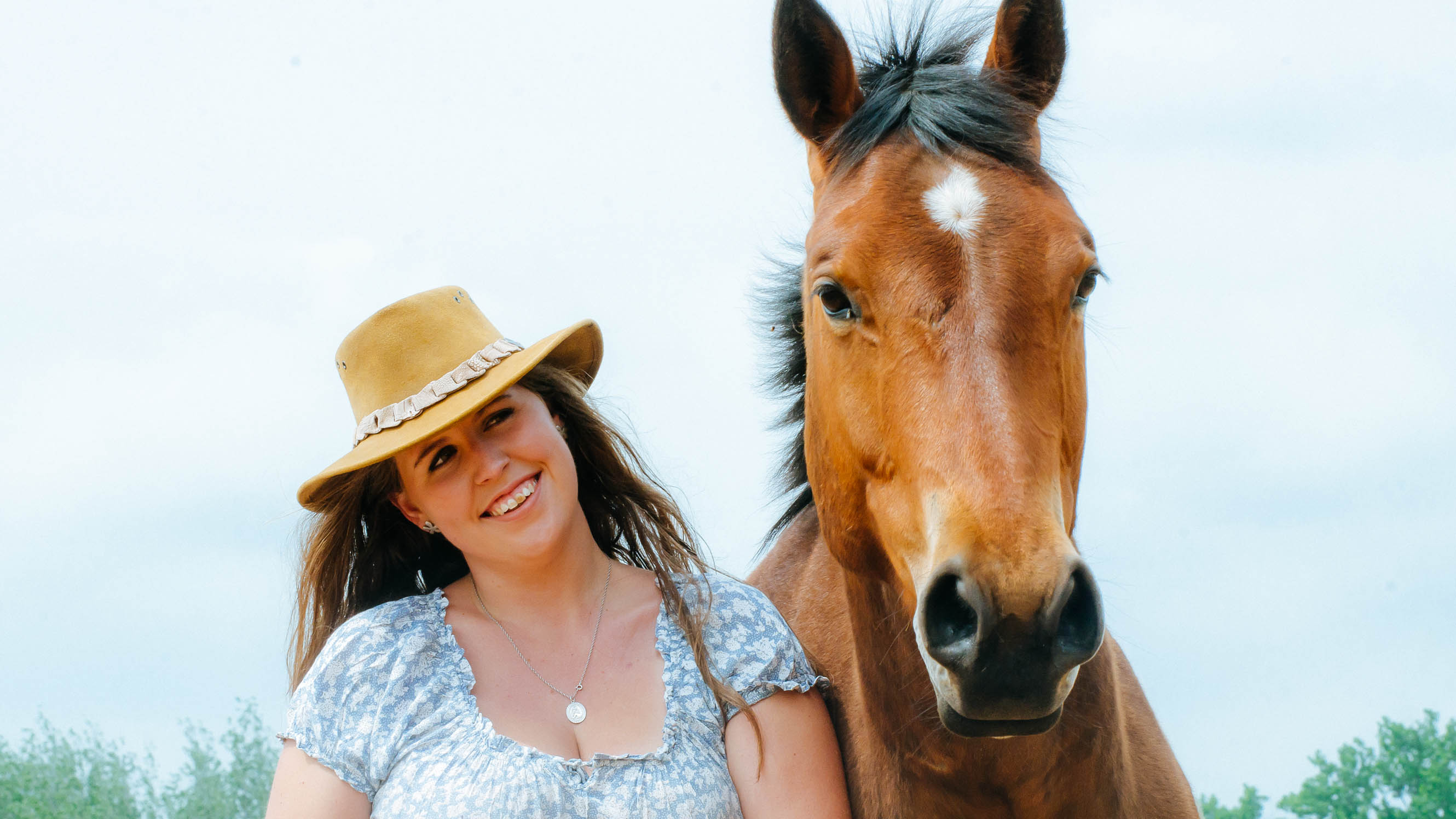 Kelly walking alongside her beloved horse, Texas