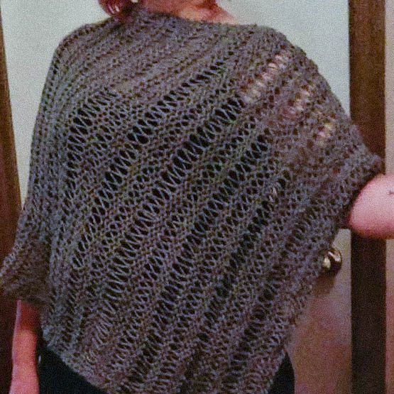 Open work grey poncho made by Shannon.